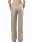 Woman wearing a beige high-waisted pants on a white background